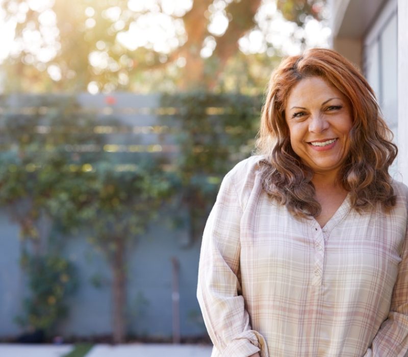 Portrait,Of,Smiling,Senior,Hispanic,Woman,In,Garden,At,Home