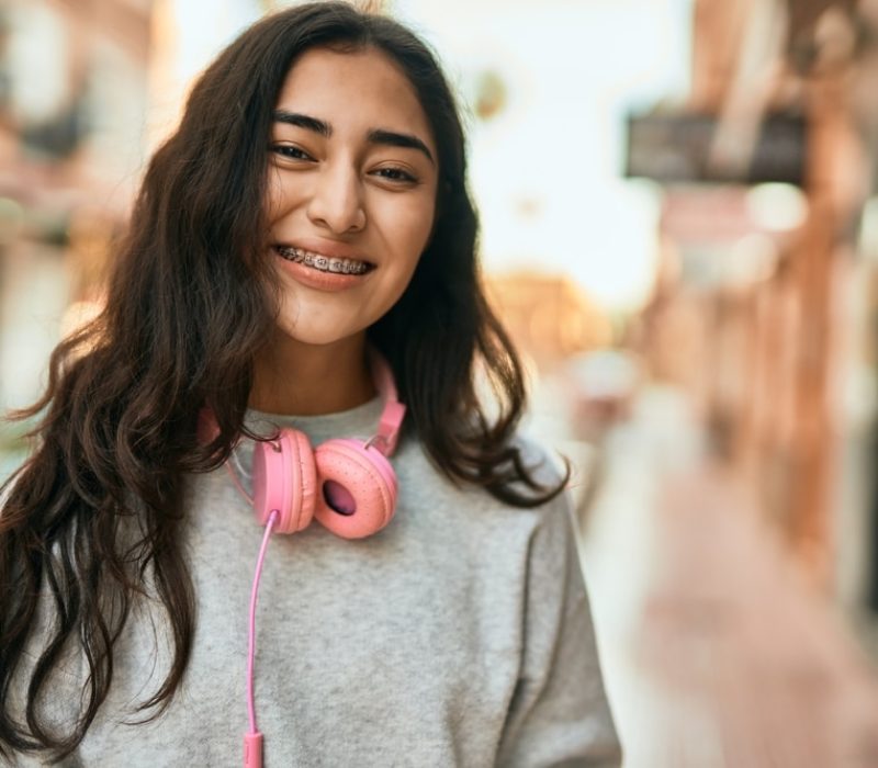 Young,Middle,East,Girl,Smiling,Happy,Using,Headphones,At,The